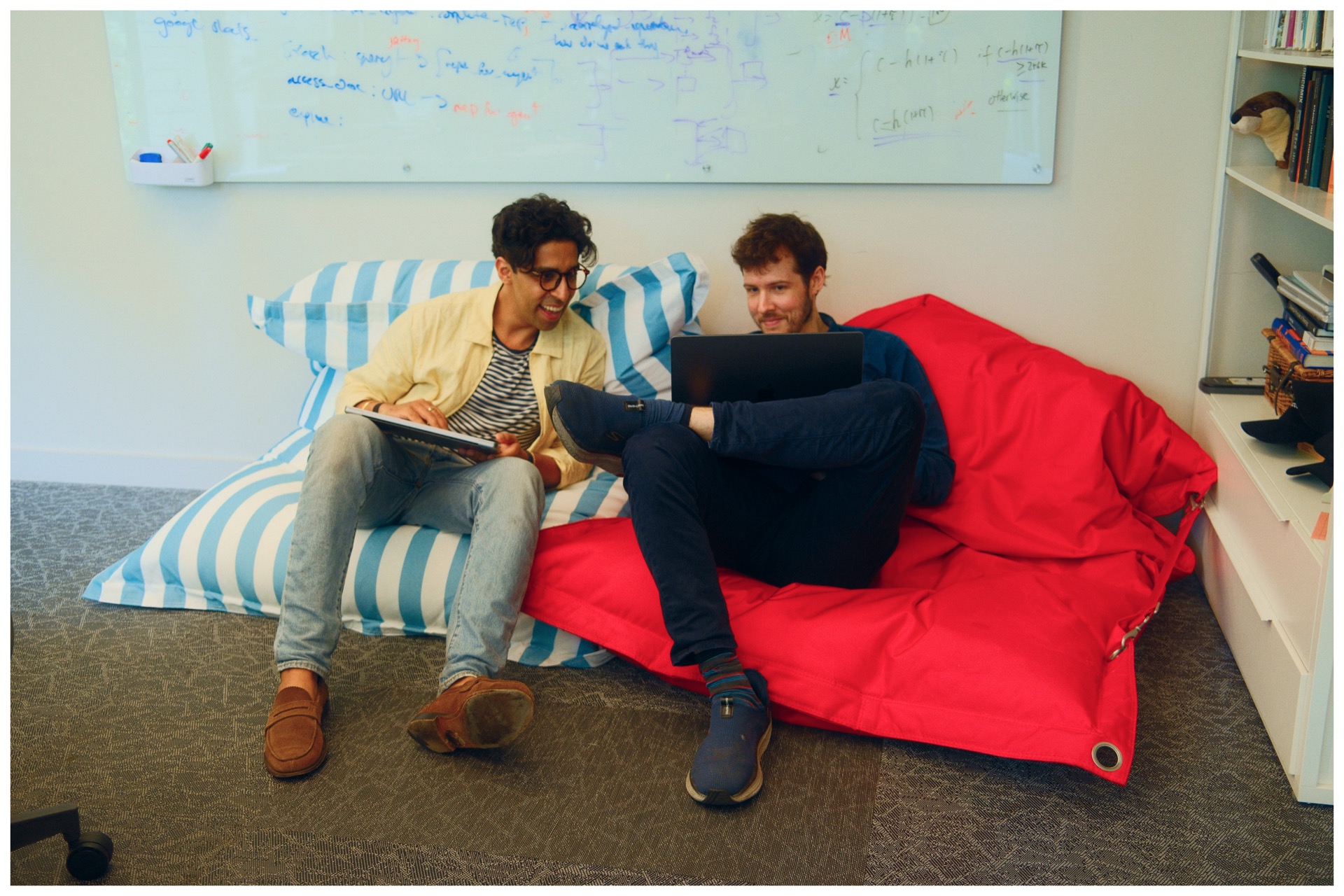 Two Catapult team members collaborating with laptops