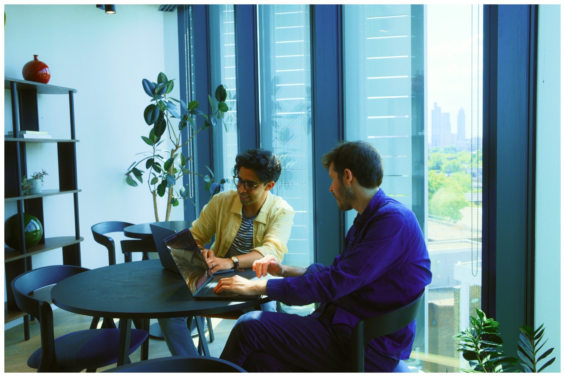 Catapult team members collaborating at a table in the office